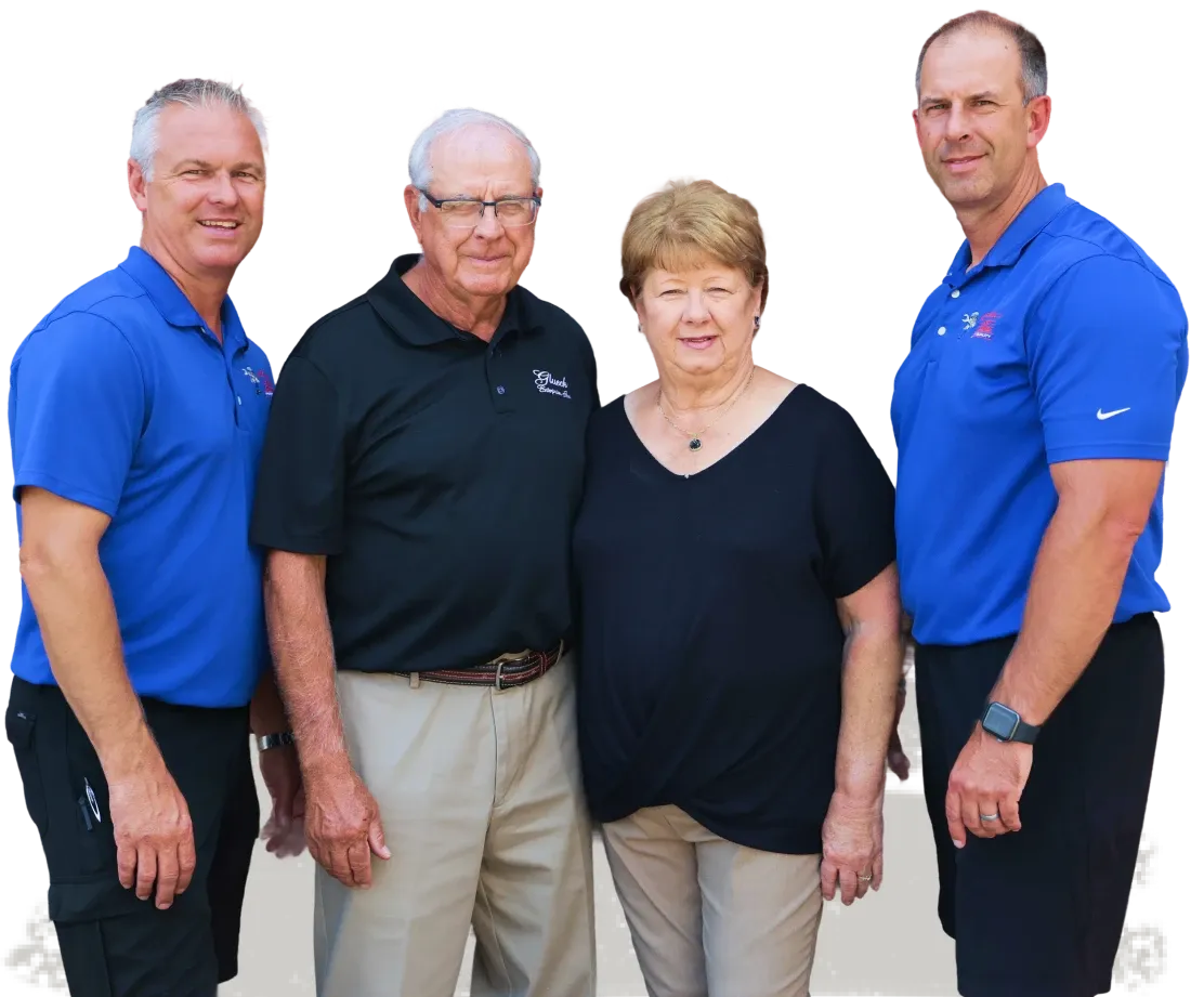 Four people posing together outdoors.