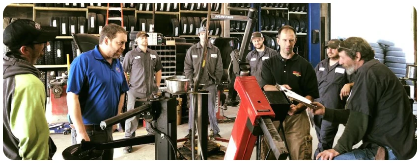 Group of workers in workshop setting.