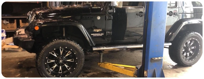 Black Jeep on a lift