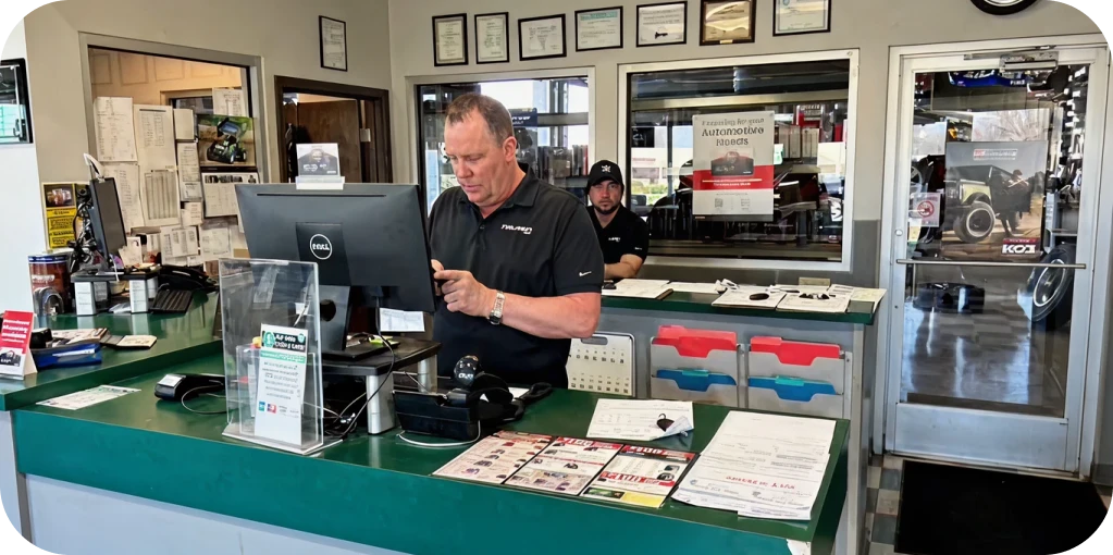 Auto Repair in Missouri & Illinois At Charlie’s Tire and Fast Lube. Auto repair shop with employees working.