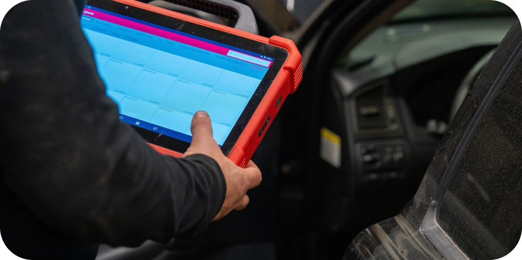 Diagnostics in Missouri & Illinois At Charlie’s Tire and Fast Lube. Person using diagnostic tablet in car