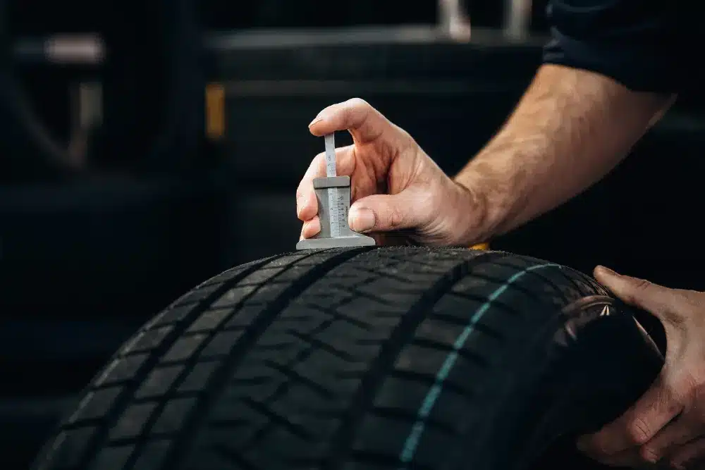 Tire and Wheel Services in Missouri by Charlie’s Tire and Automotive, a mechanic checking a car tire during regular maintenance
