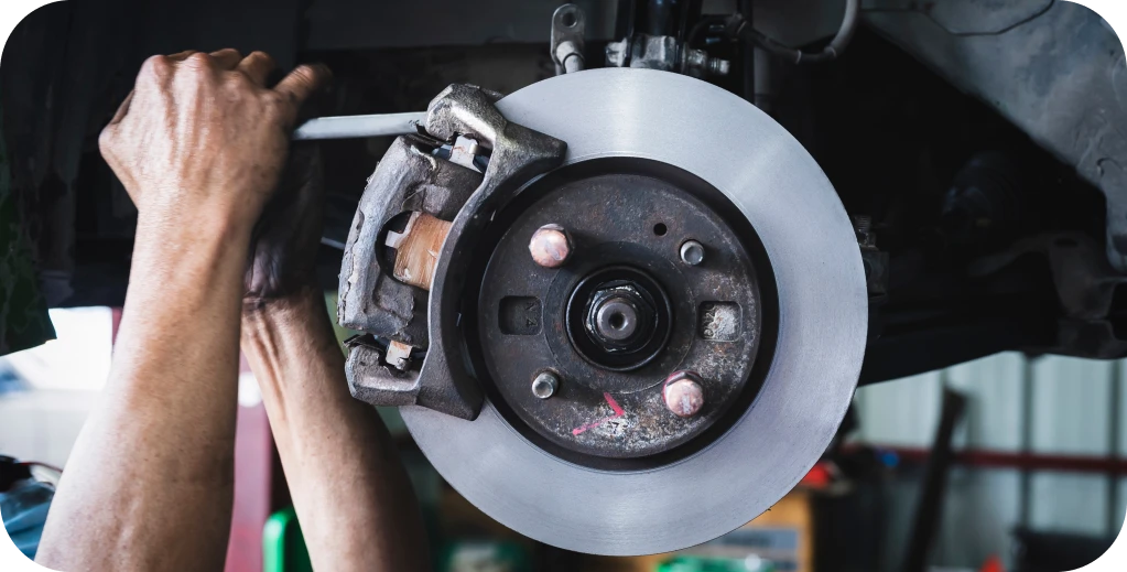 Brake Repair in Missouri and Illinois At Charlie’s Tire and Fast Lube. Hands repairing a car brake system
