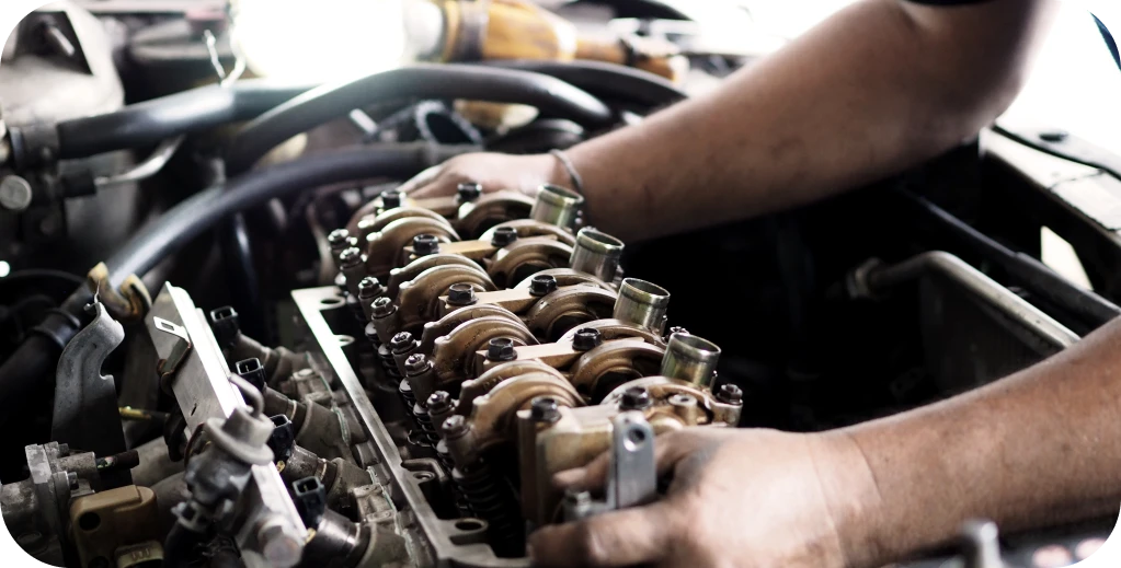 Engine Repair in Missouri and Illinois At Charlie’s Tire and Fast Lube. Hands working on an engine component