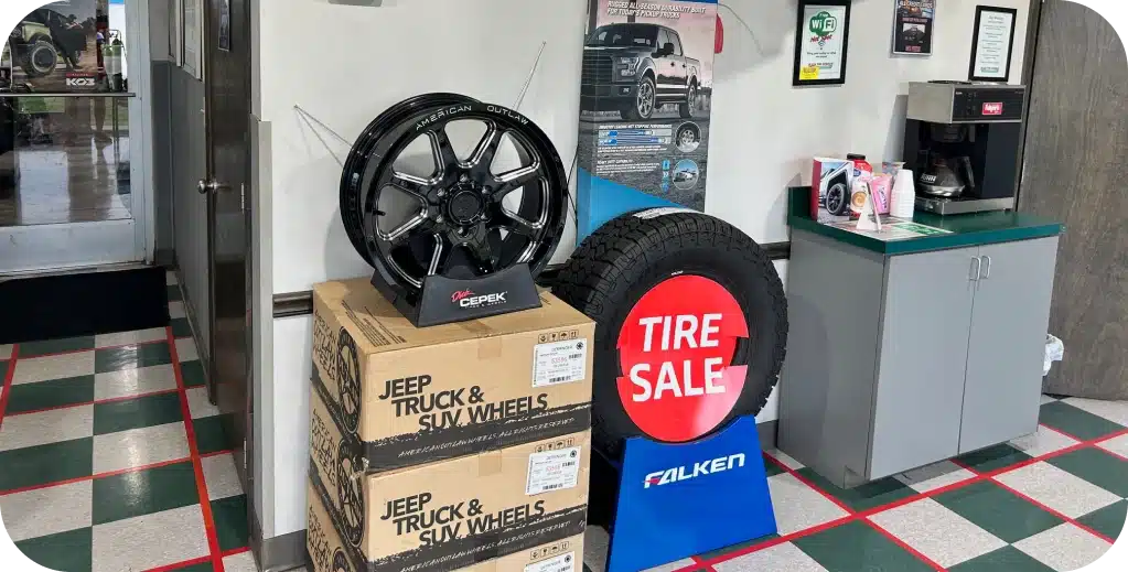 Tire Services in Missouri and Illinois At Charlie’s Tire and Fast Lube. Tire sale display with wheels