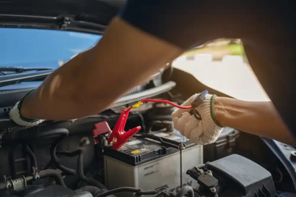 Battery and Electrical Service in Missouri by Charlie’s Tire and Automotive, a mechanic checking a vehicle’s battery during routine maintenance